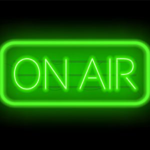 On air glowing sign on a dark background.